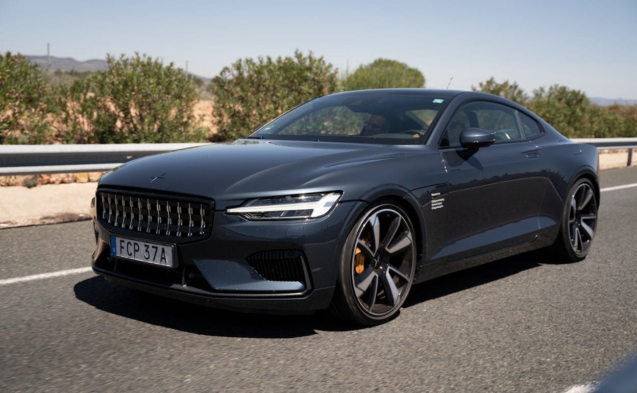 A Polestar 1 in the colour Black Midnight driving on a road.