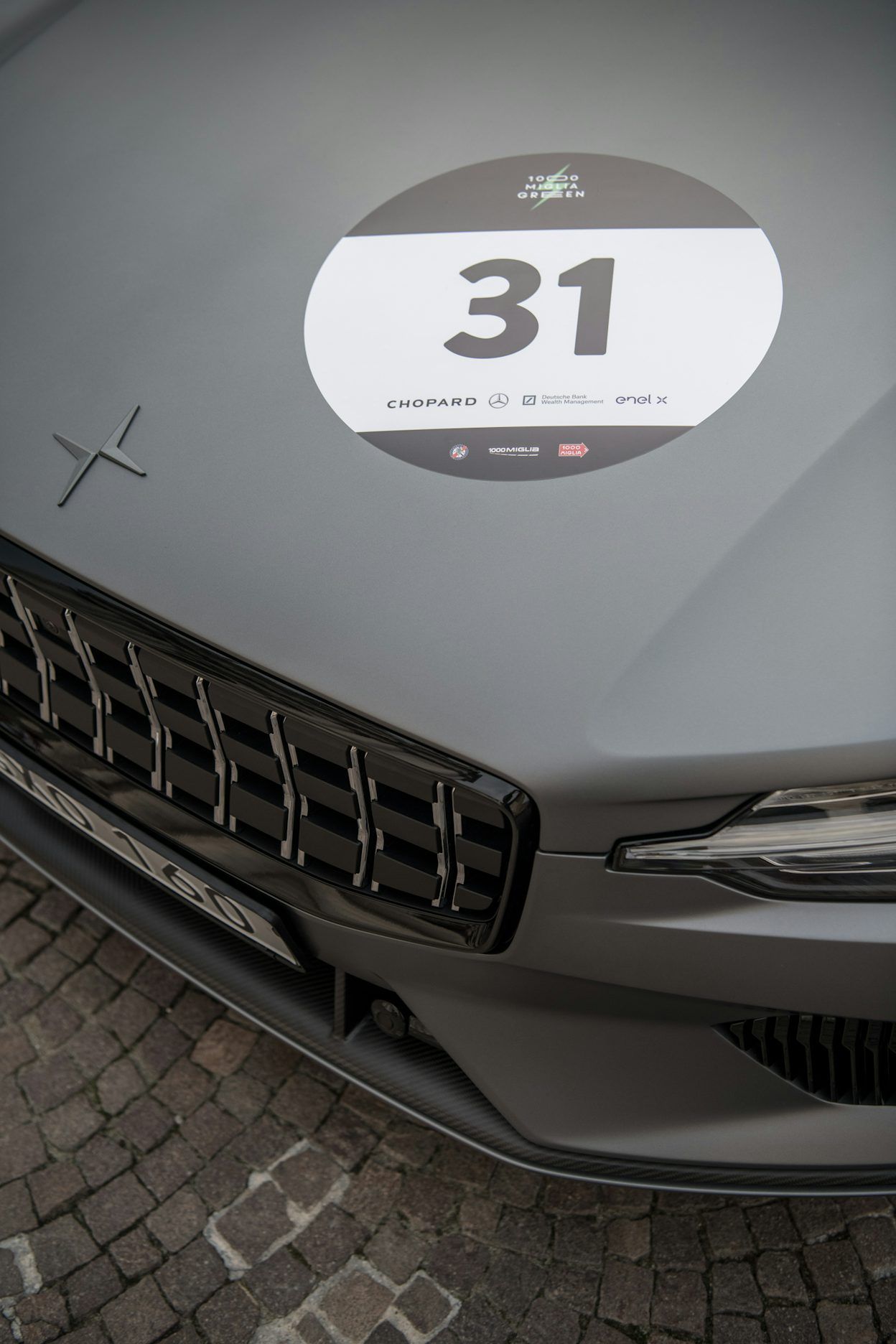A close-up of a sticker with the number 31 placed on the hood of a Polestar.