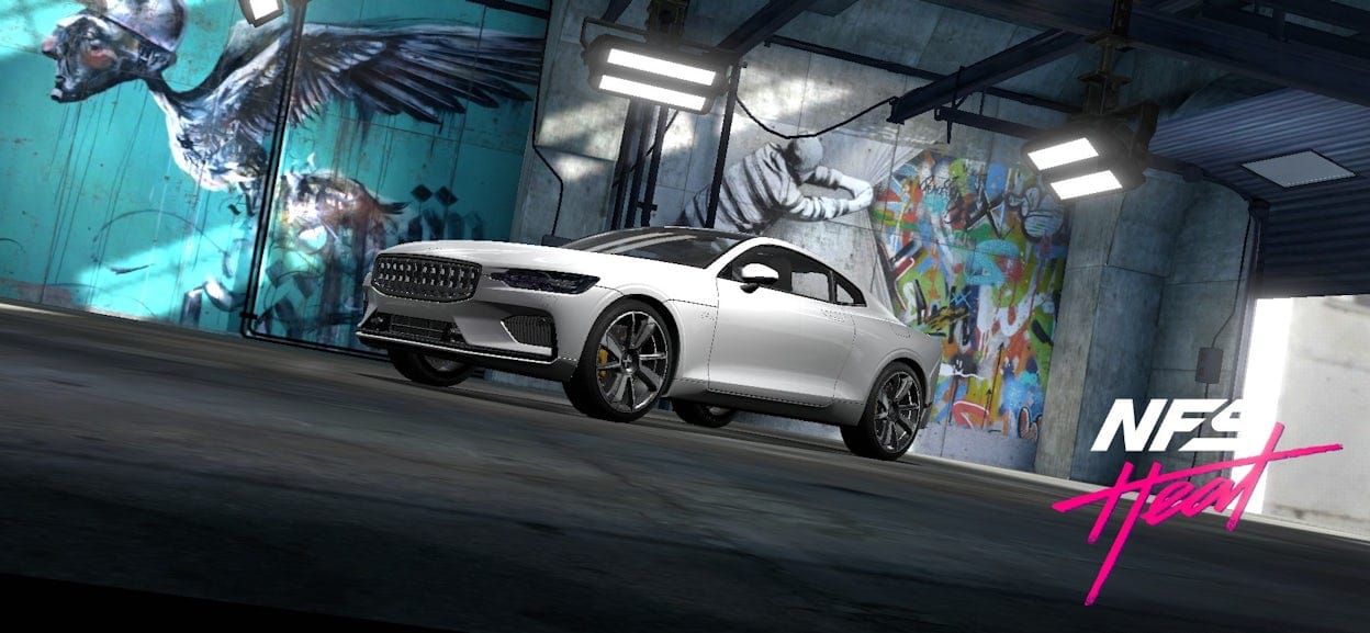 A silver Polestar in a concrete garage with street art and the NFS Heat logo