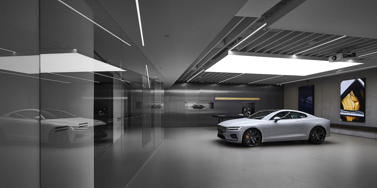 White Polestar 1 displayed in grey coloured, minimalistic retail space