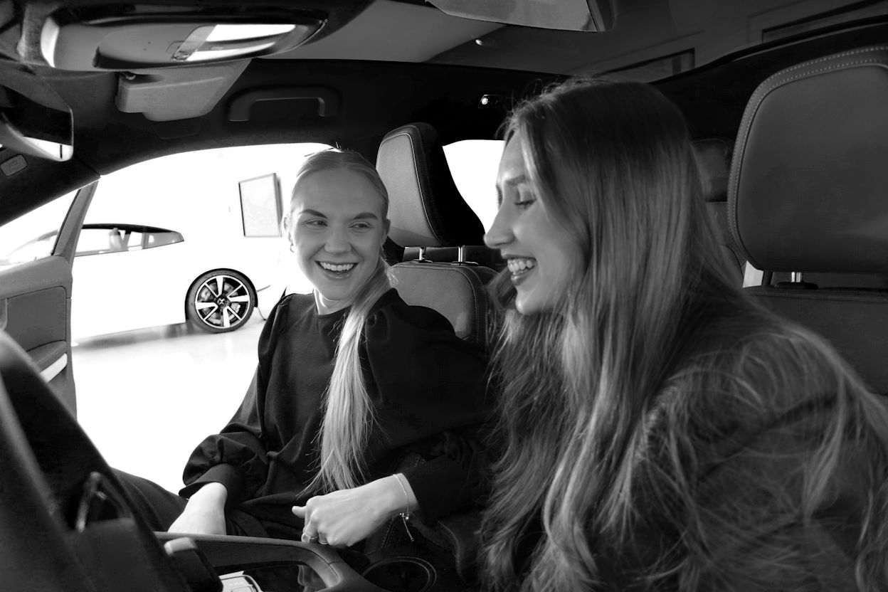 Sofia and Malin smiling in the front seat of a Polestar