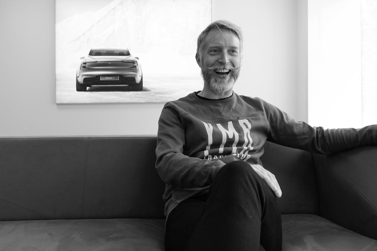 Stefan Kinell sitting on a couch , laughing.