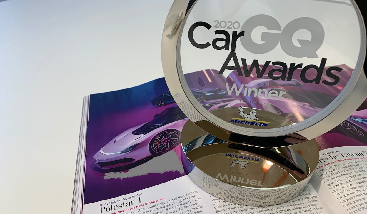 The 2020 GQ Car Awards trophy standing on a newspaper opened to a page about Polestar 1