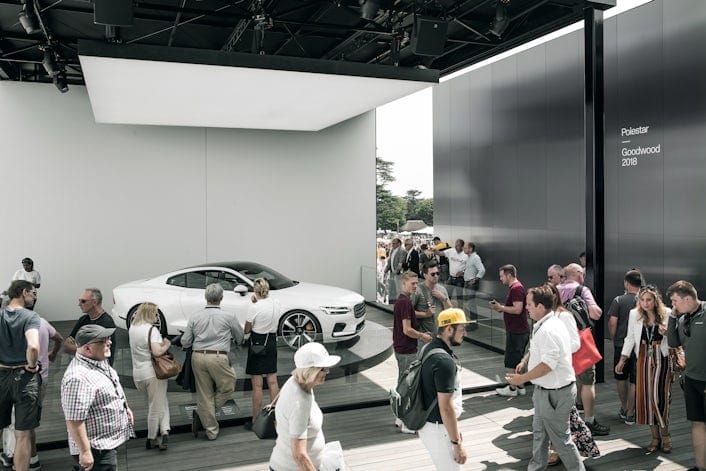 People looking at a white Polestar 1 on display at the Goodwood Festival of Speed.