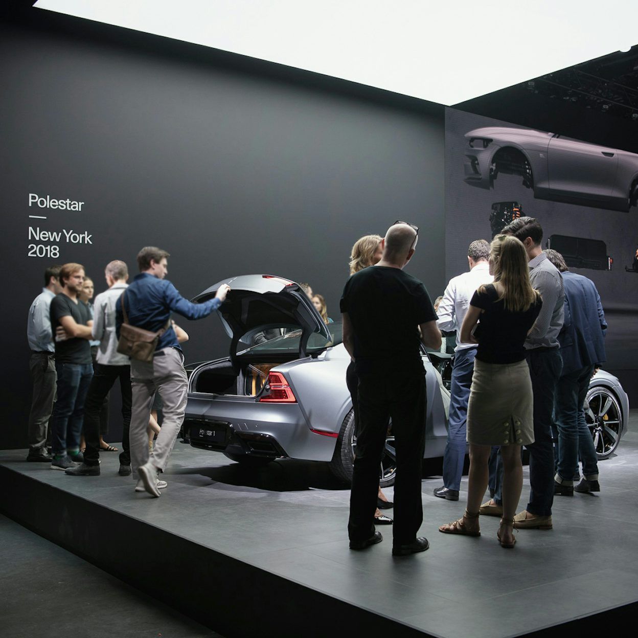 People gathered around a silver Polestar 1 on display at the Polestar New York event 2018.