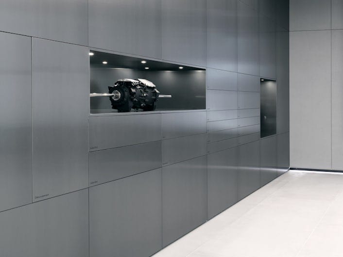 A wall of grey cabinets with a Polestar electric motor on display.