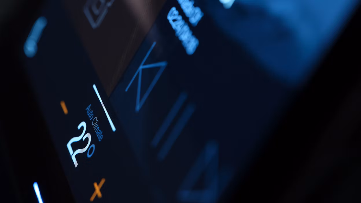 A close-up of a in-car display with the temperature control in focus.