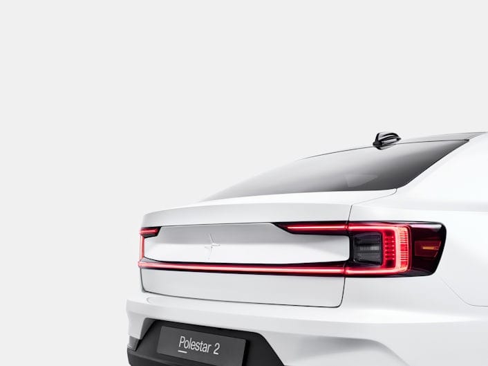 The back of a white Polestar 2 with the brake lights on.
