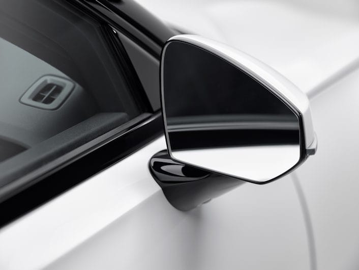 A close-up of a rearview mirror on a white Polestar.