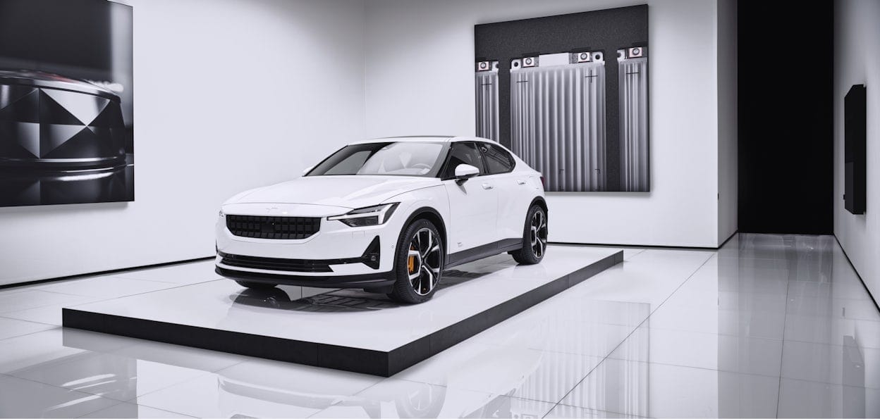A white Polestar on a white stand in a white room