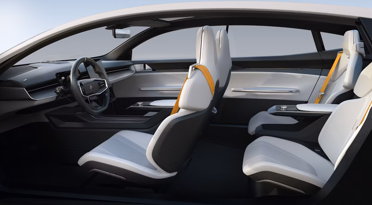The inside of a Polestar Precept showing four white seats with yellow seatbelts.