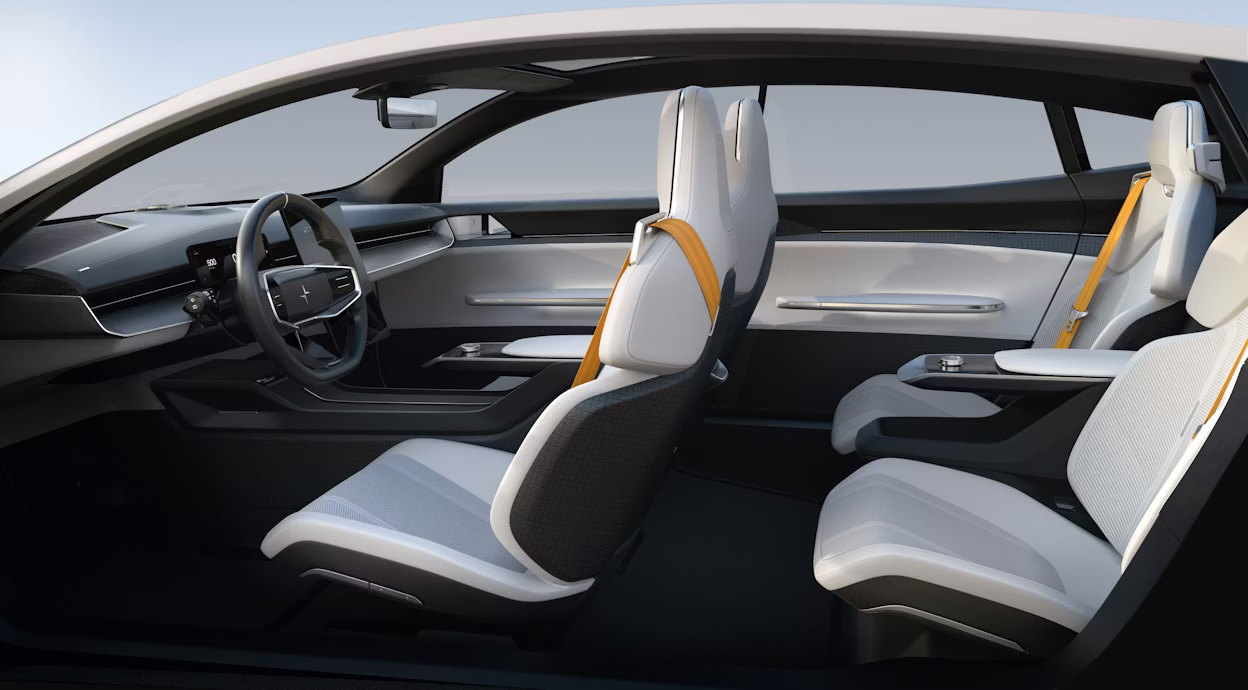 The inside of a Polestar Precept showing four white seats with yellow seatbelts.