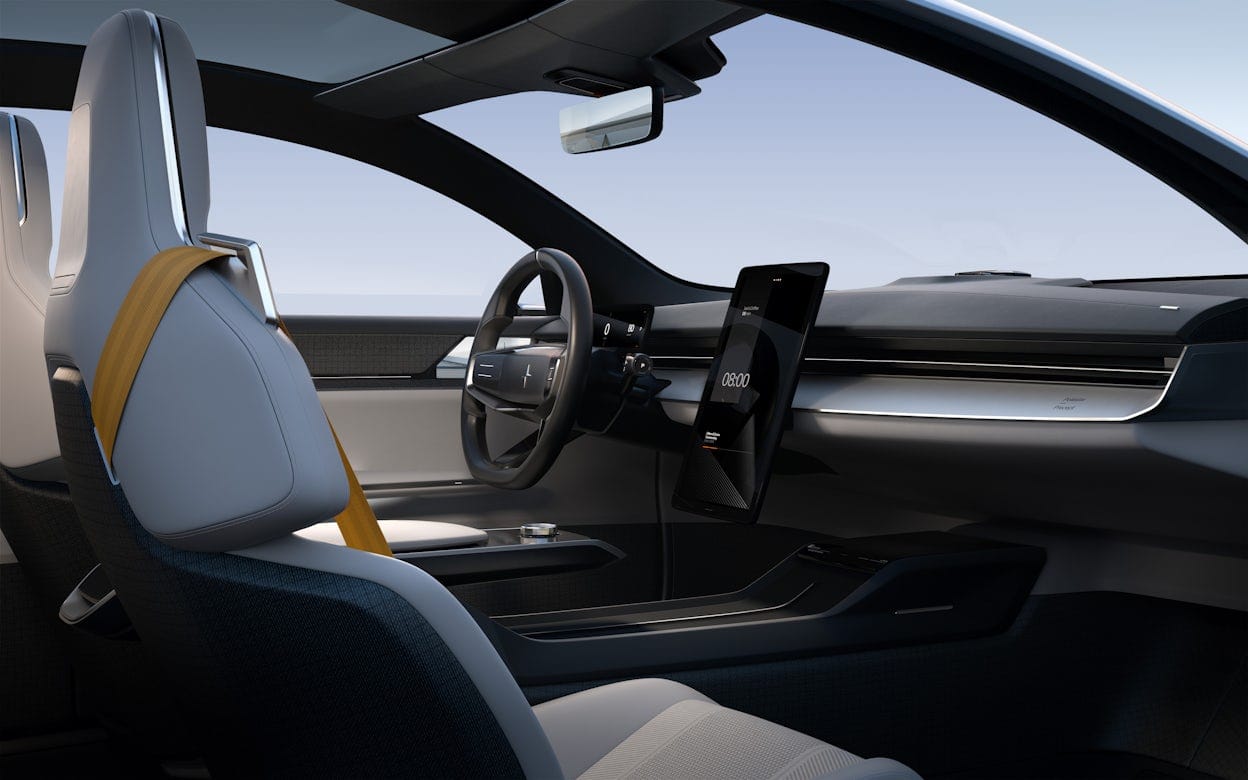 The front seats and steering wheel in a Polestar Precept viewed from behind.