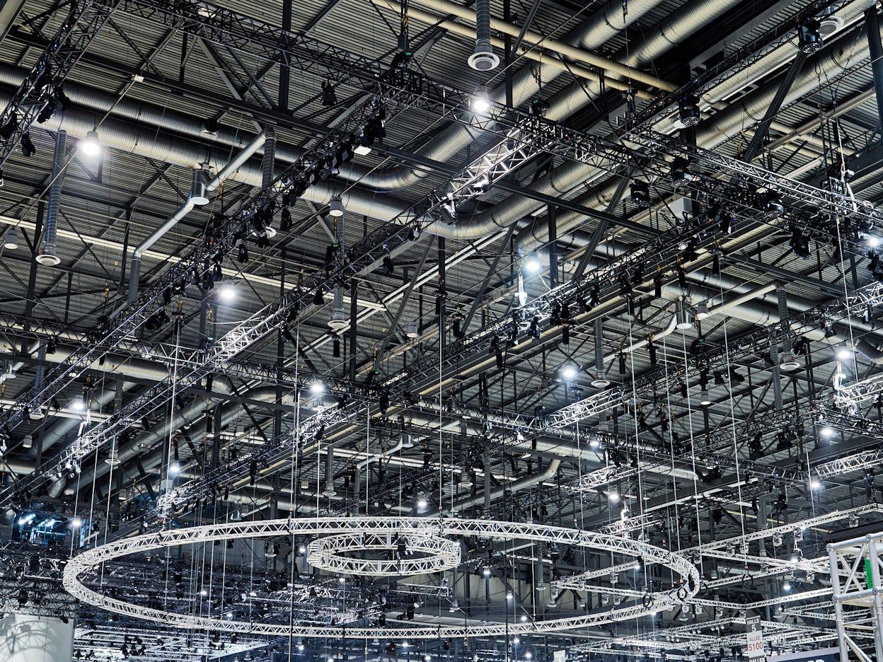 A ceiling with studio spotlights and black truss grids