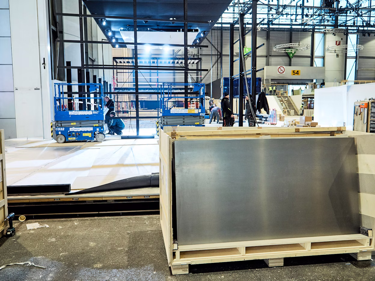 Construction of the Polestar stand in a large warehouse.