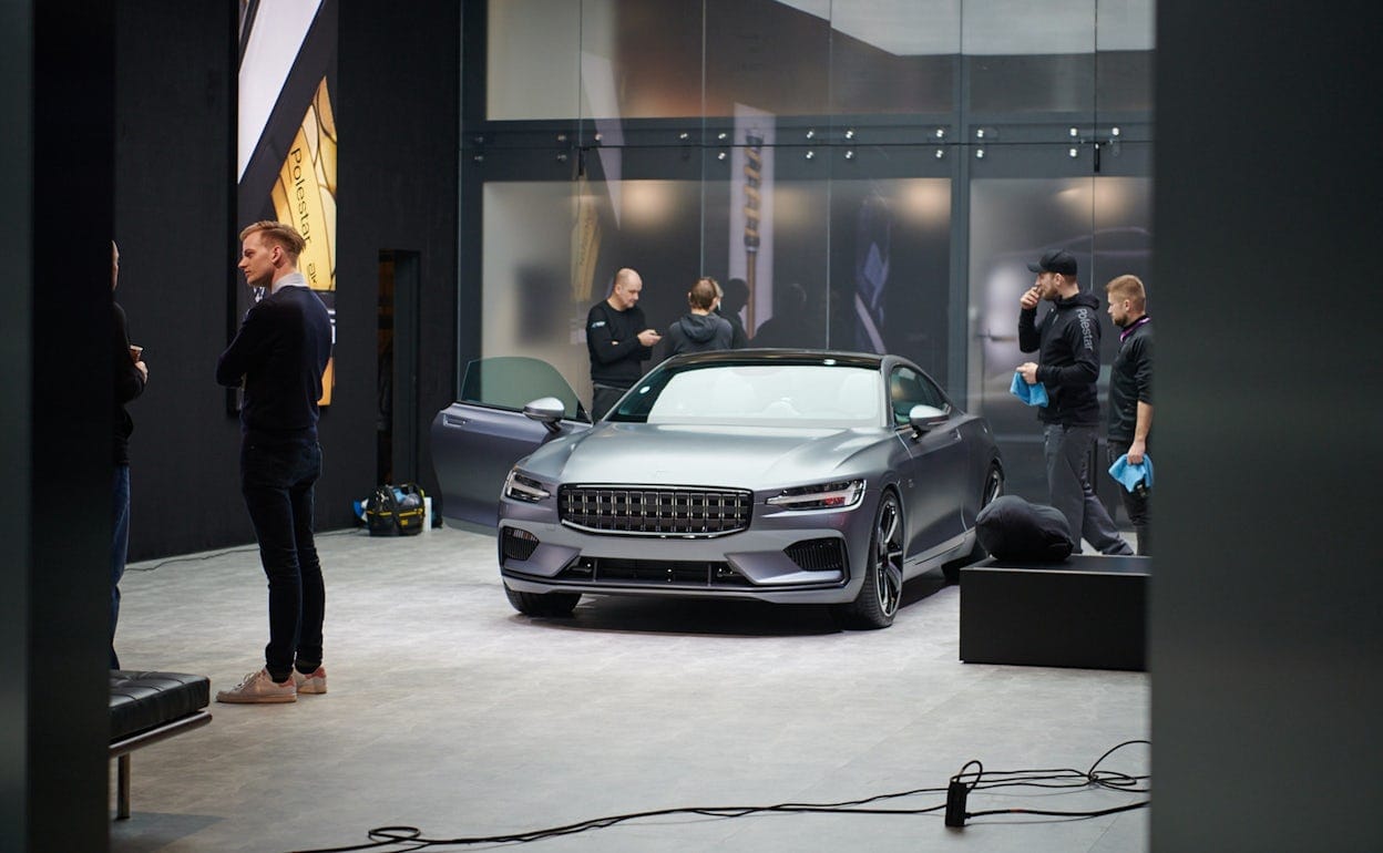 People in Polestar outfits gathered around a silver Polestar