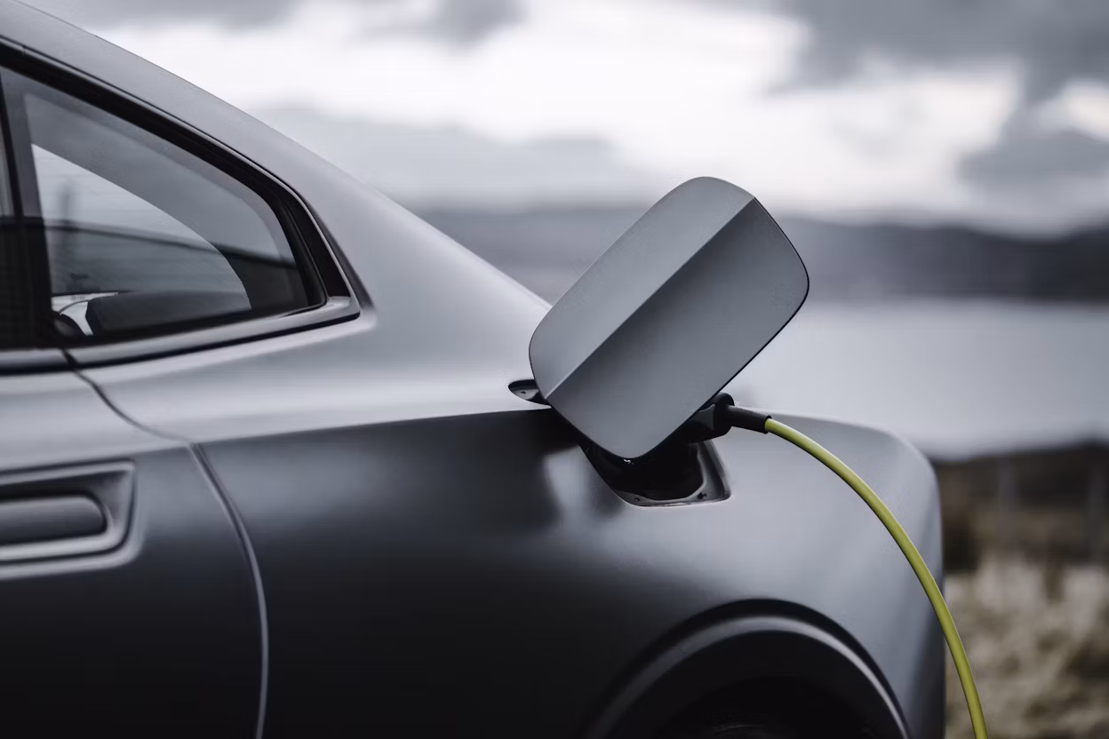 Close-up of a grey Polestar 1 with the charging cable connected