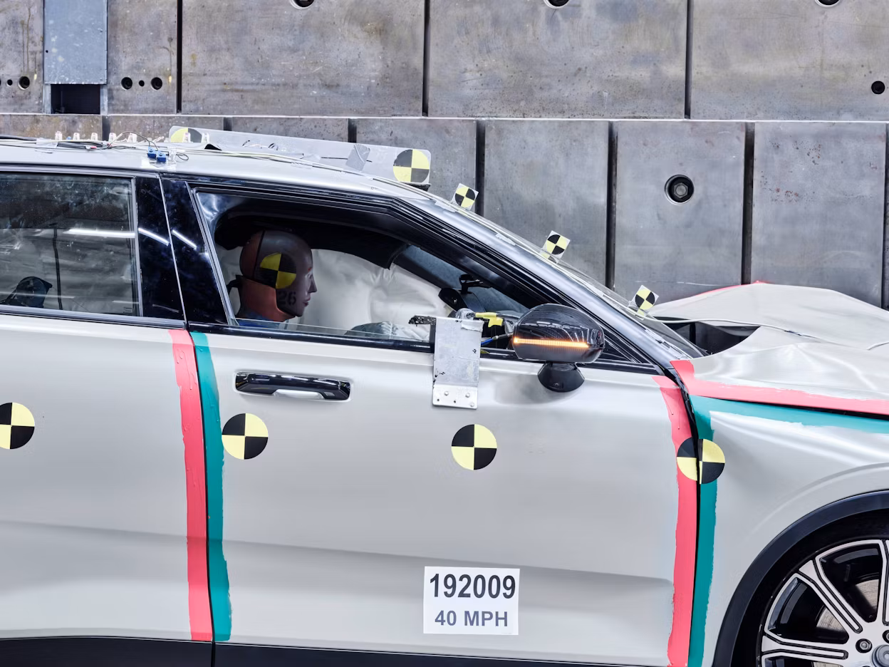 A crash test dummy behind the wheel in a Polestar 2.