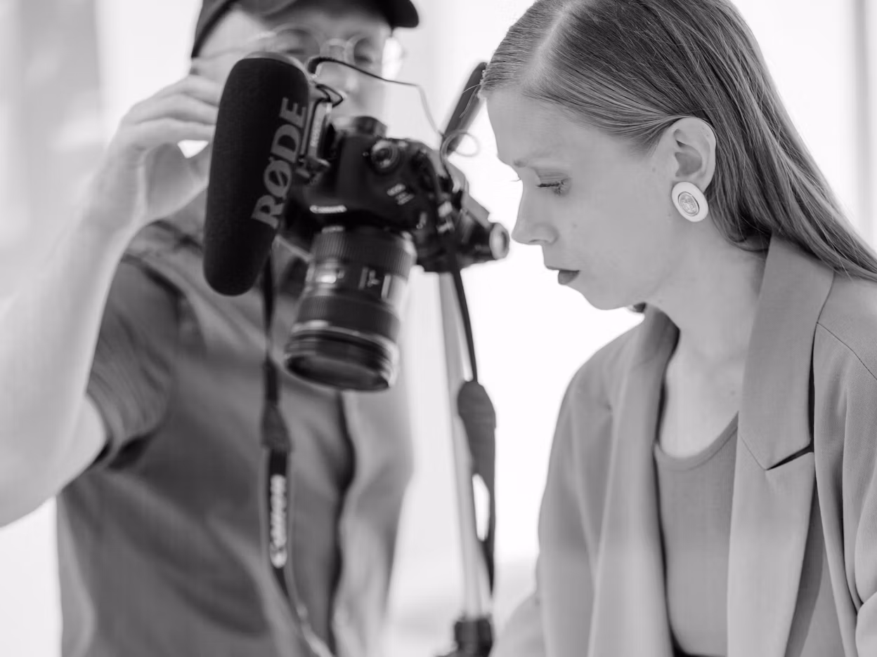 Jenny Mustard and a photographer photographed in black and white.