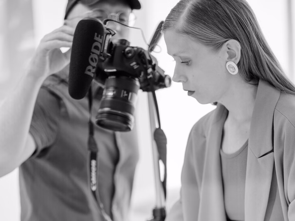 Jenny Mustard and a photographer photographed in black and white.