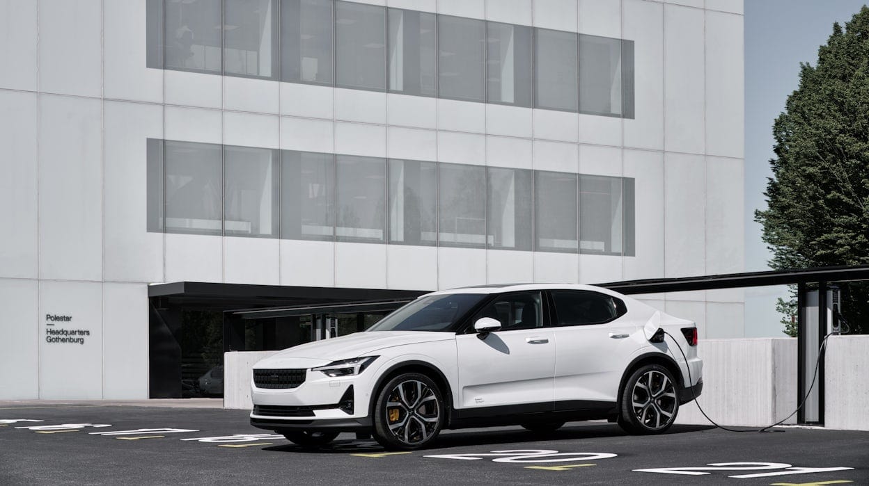 A white Polestar 2 parked in front of the Polestar Headquarters Gothenburg