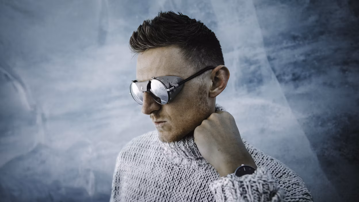 Jack Harding wearing goggles, photographed with a blue background.