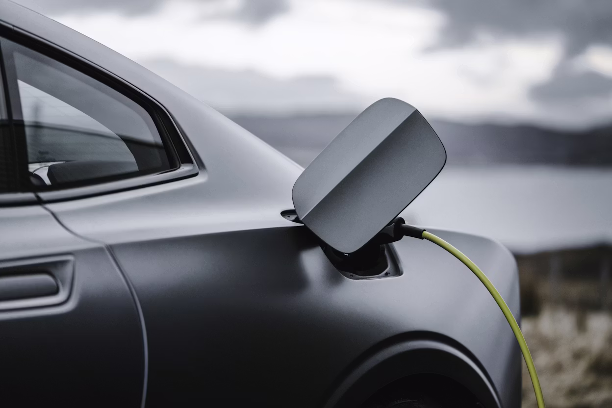 Close-up of a grey Polestar 1 with the charging cable connected.
