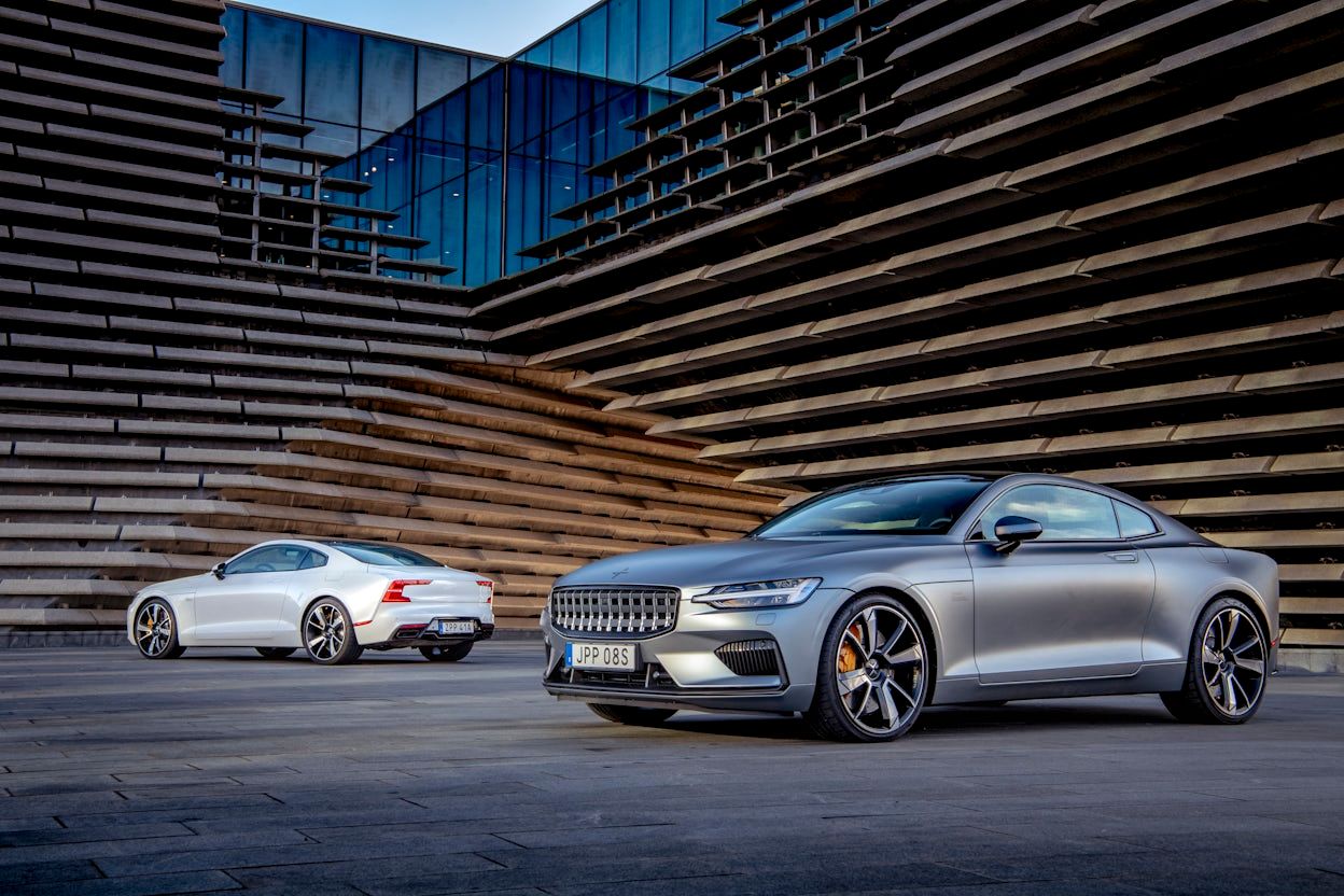 Two Polestar 1, one grey and one white photographed outside a building