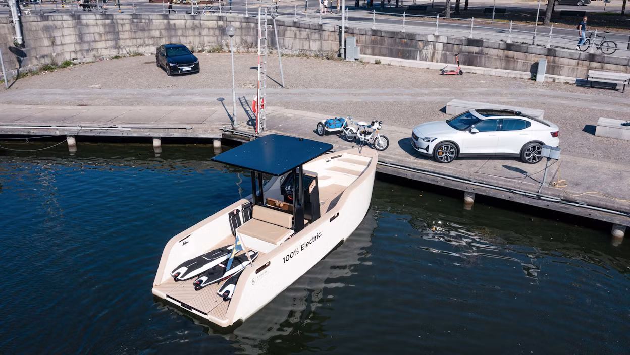 Electric boat, electric motorbike and a Polestar 2 parked at a dock in Stockholm.