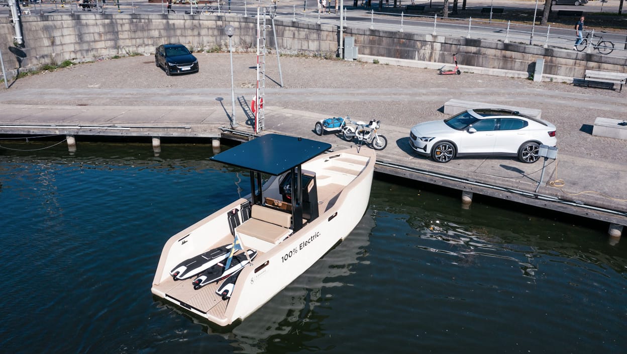 Electric boat, electric motorbike and a Polestar 2 at a dock