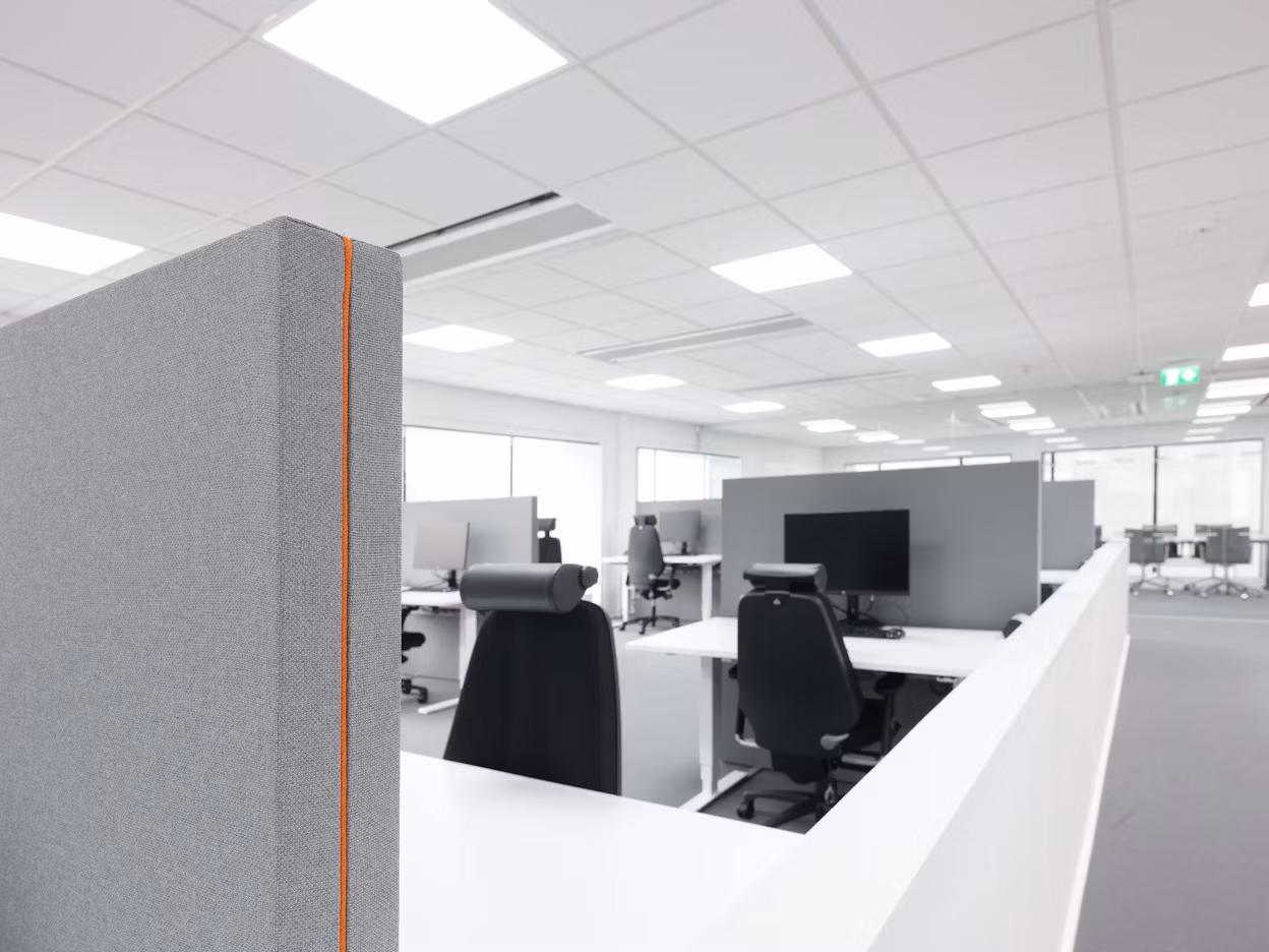 Minimalistic black and white office interior with cubicles.