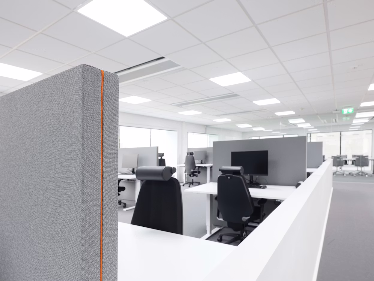 Minimalistic black and white office interior with cubicles.
