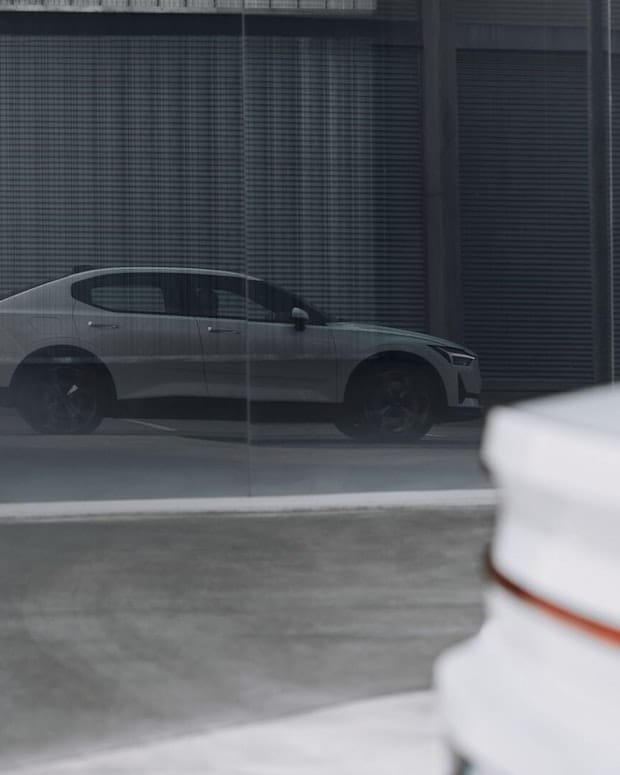 Side view of grey Polestar 2 parked in an industrial environment 