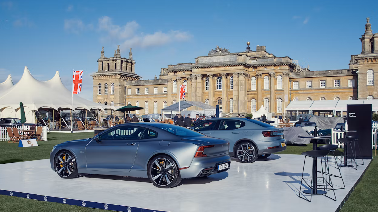 A Polestar 1 and a Polestar 2 on display in front of Blenheim Palace.