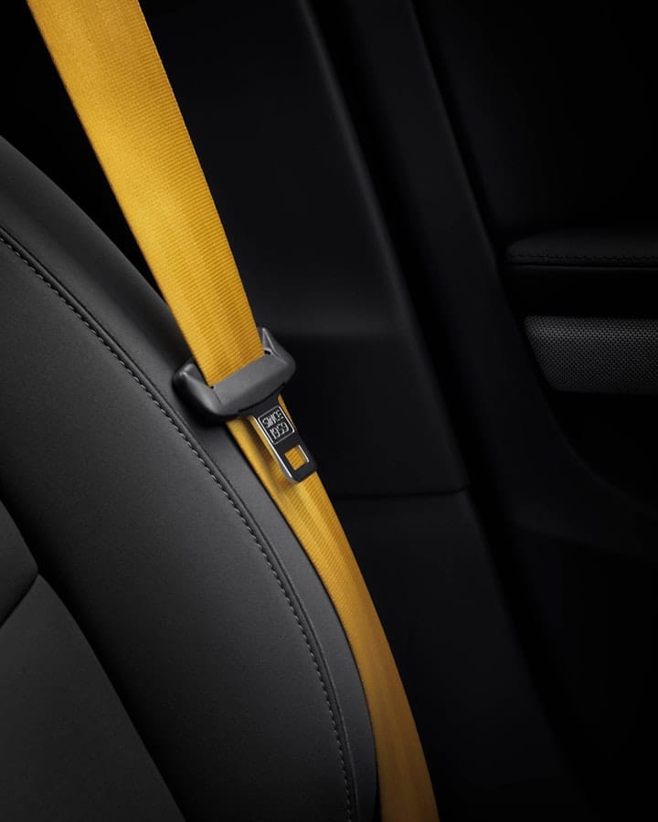 Close-up of a black car-seat with yellow seat-belt