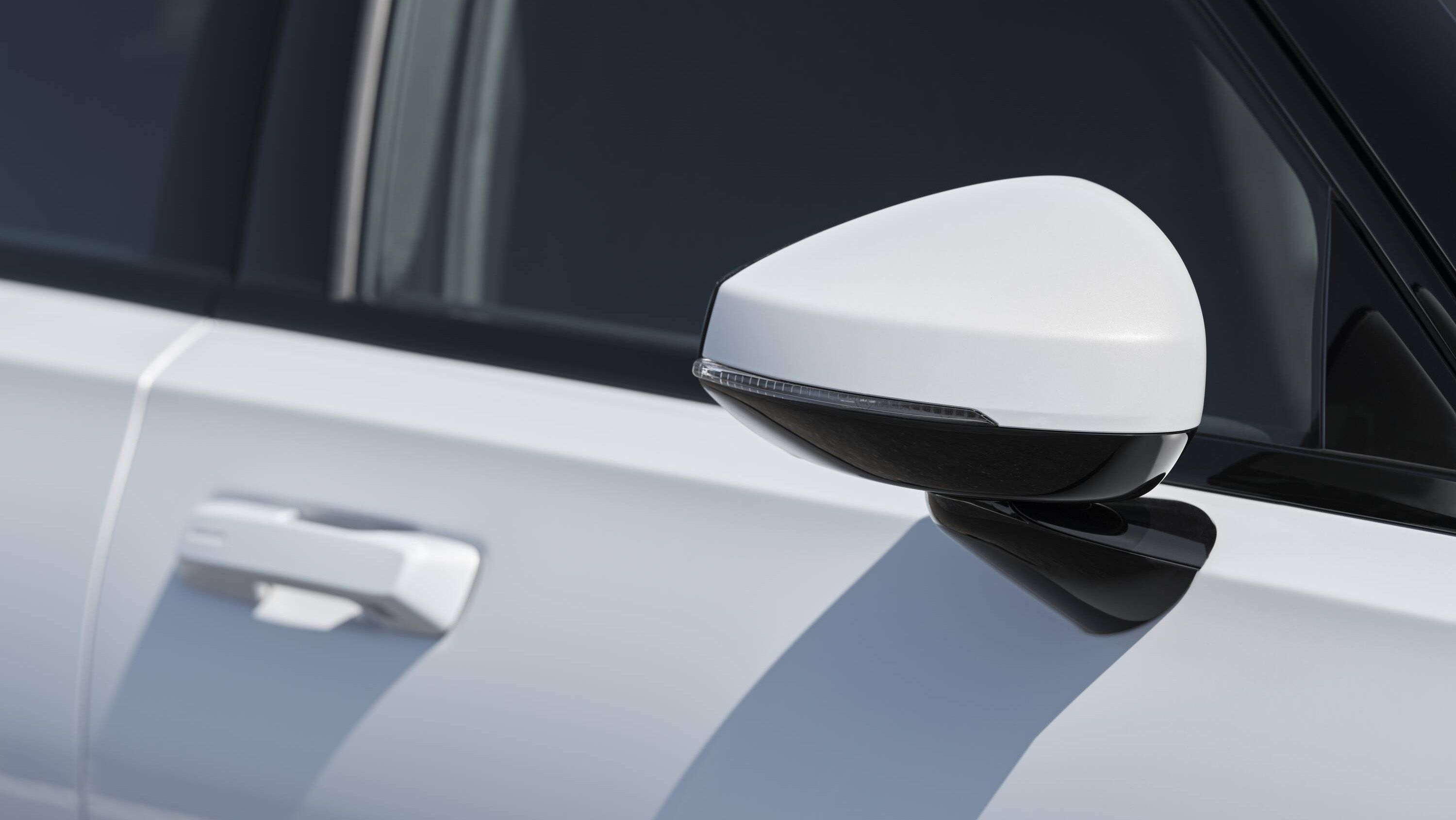Exterior side mirror of white Polestar 2 from the front side