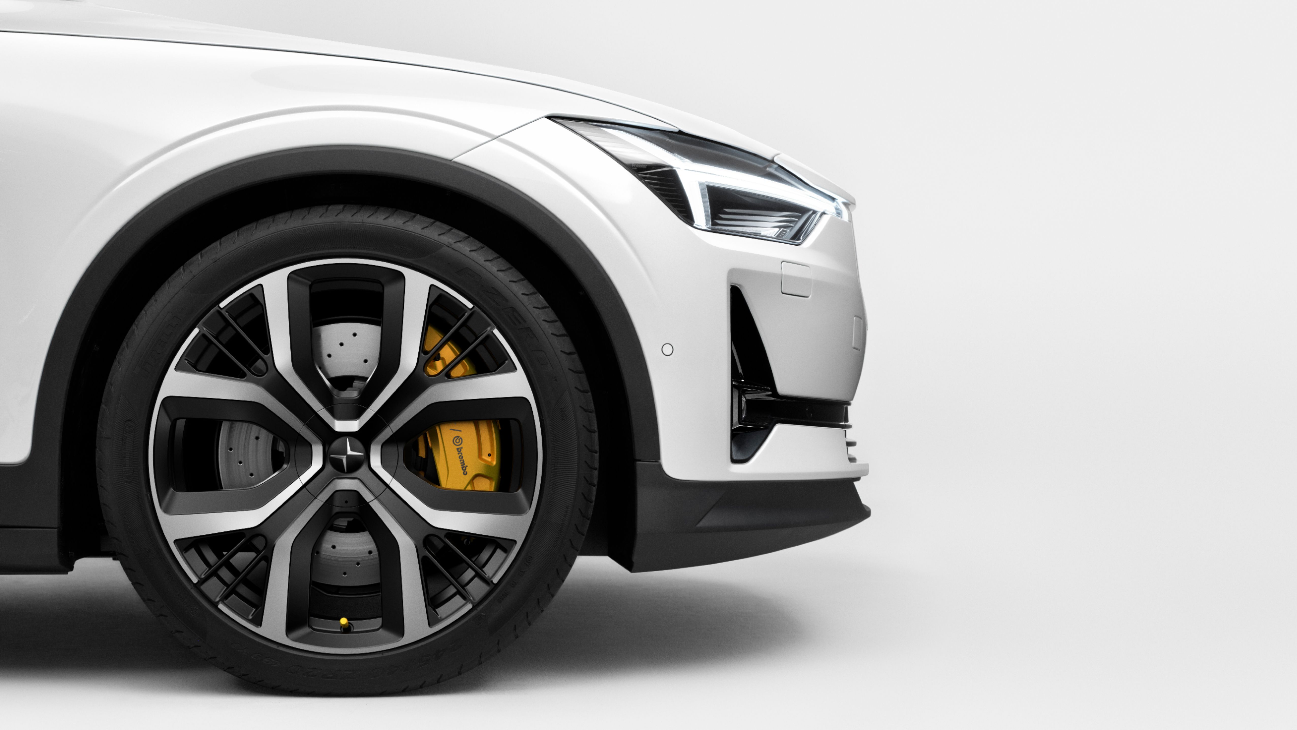 Side front detail of the wheel of a white Polestar 2
