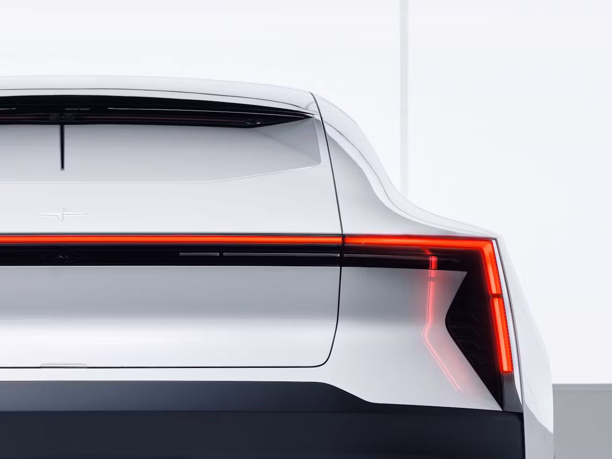 Back view of a white Polestar 2 with illuminated brake light.
