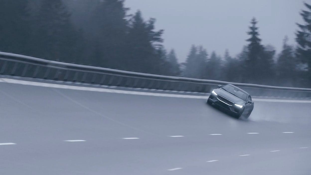Polestar 1 driving in high speed on motorway in rainy weather 
