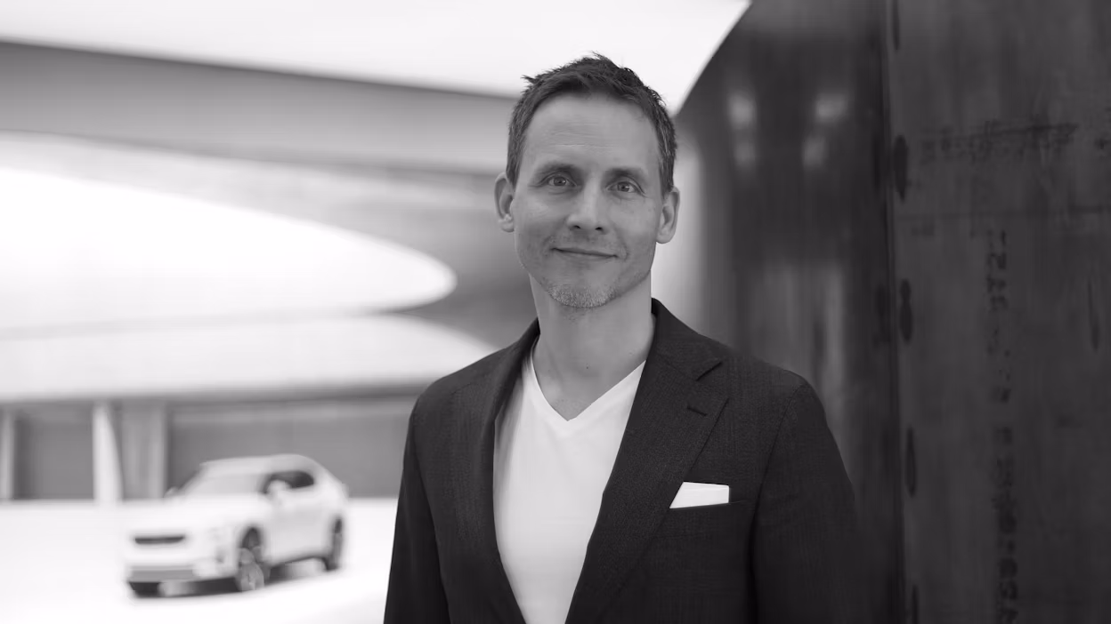 Nils Mösko smiling and looking into the camera, standing in a Polestar space.