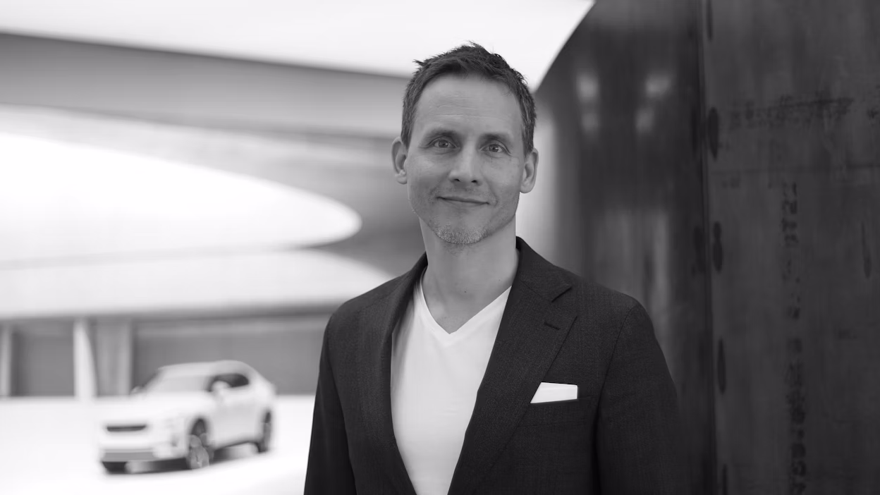Nils Mösko smiling and looking into the camera, standing in a Polestar space.