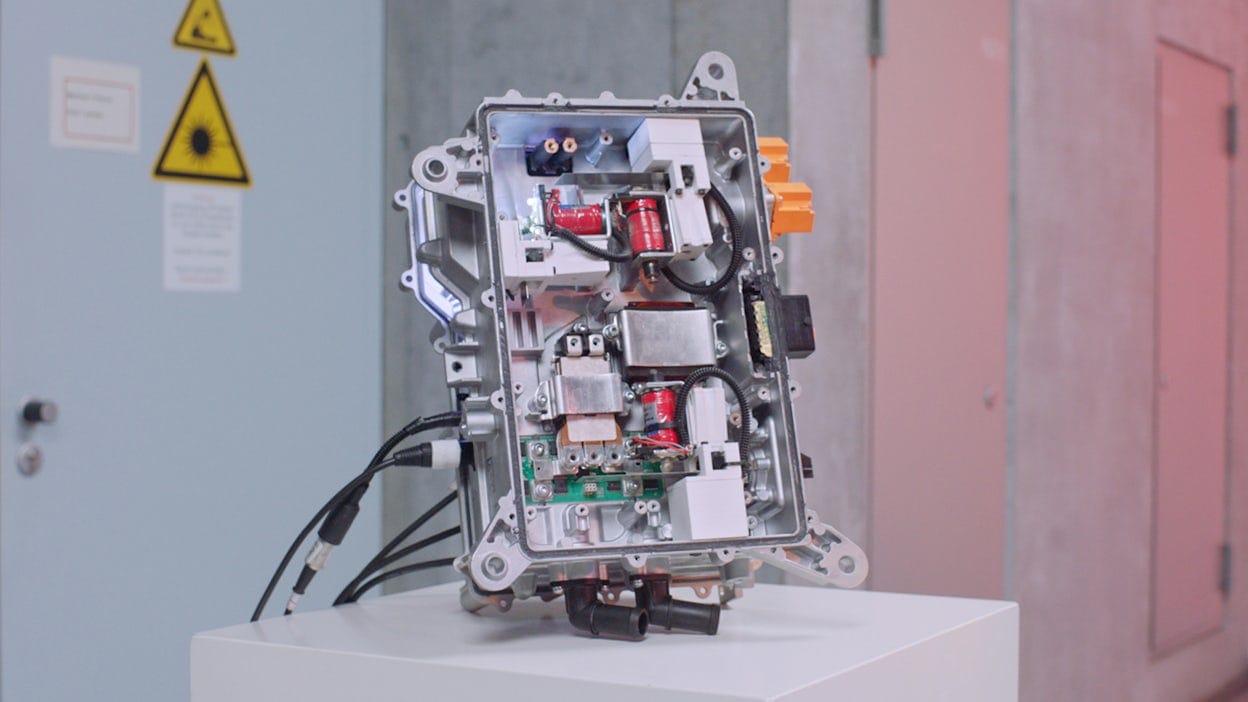 Robot made from Polestar 2 components displayed on a white table.