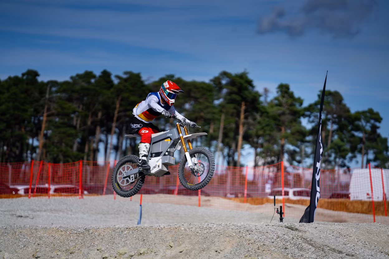 Cake bike contestant soaring through the air on a jump.