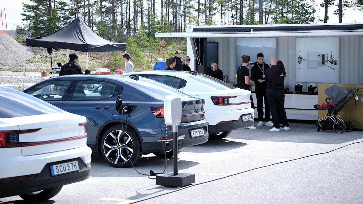 Polestar 2 cars parked next to each other with event visitors gathered around