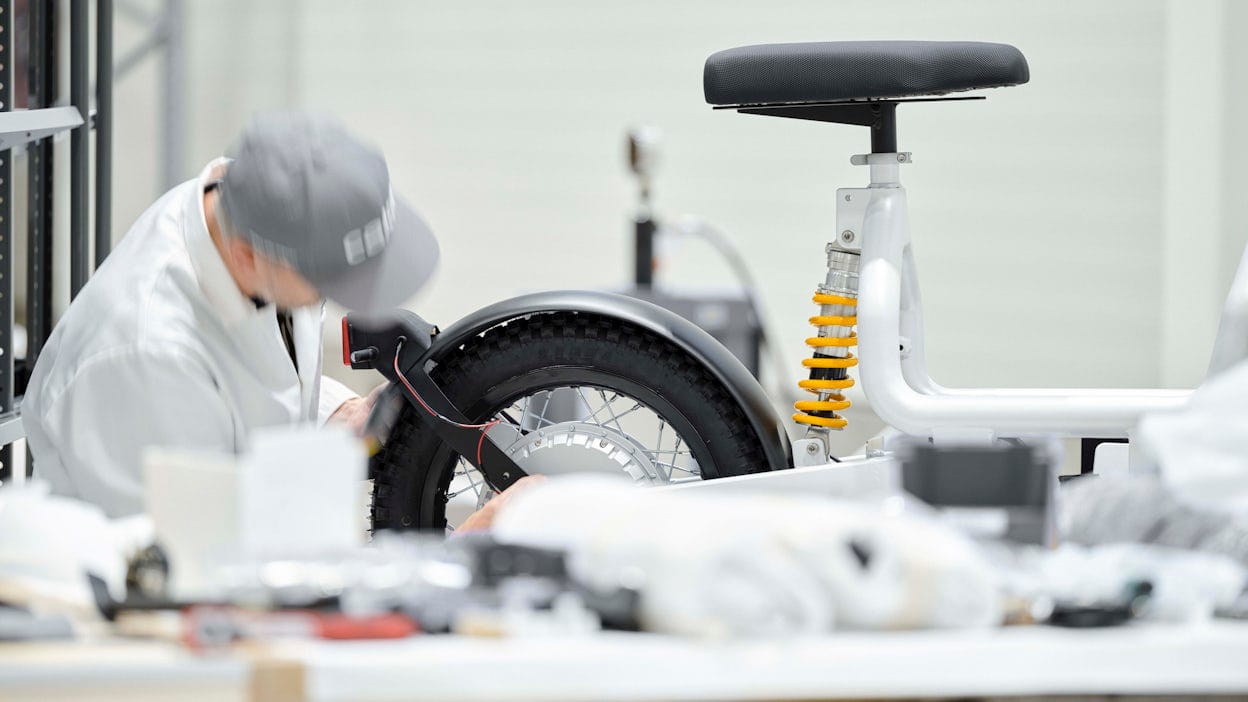 Technician working on the wheel of a Makka electric bike.