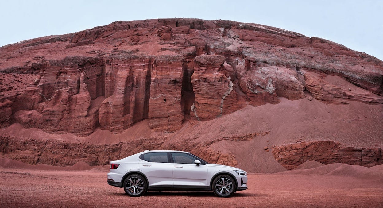 Side view of a brand new Polestar 2 in the red desert.