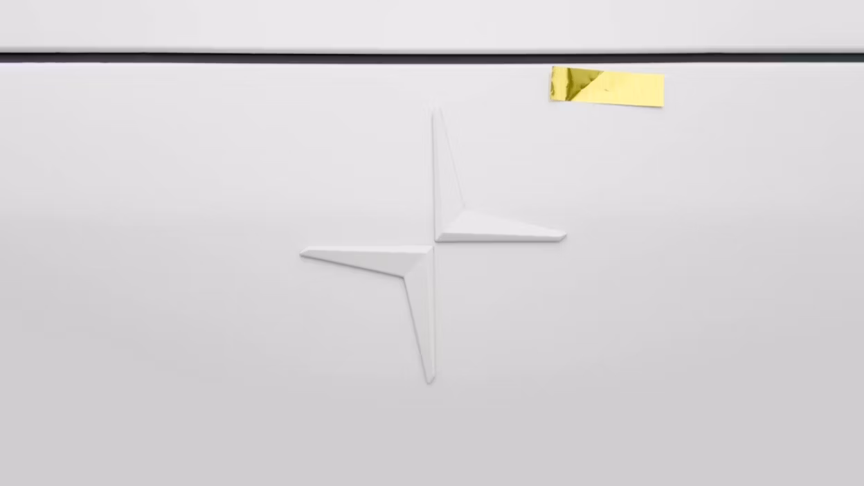 Close-up of a Polestar logo with a golden piece of tape placed on top.