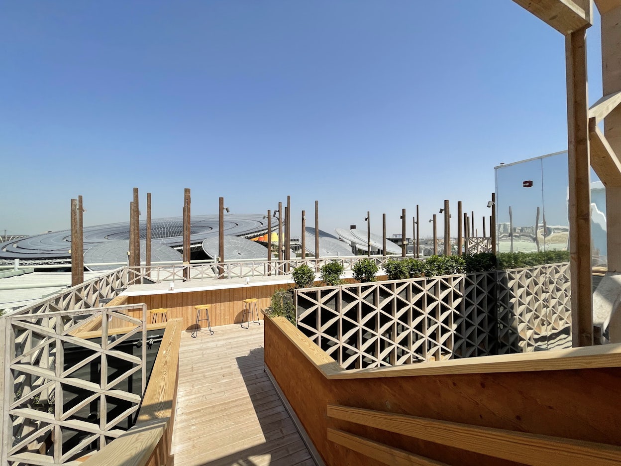 Wooden outdoor terrace under a clear blue sky at the Expo 2020 Dubai.