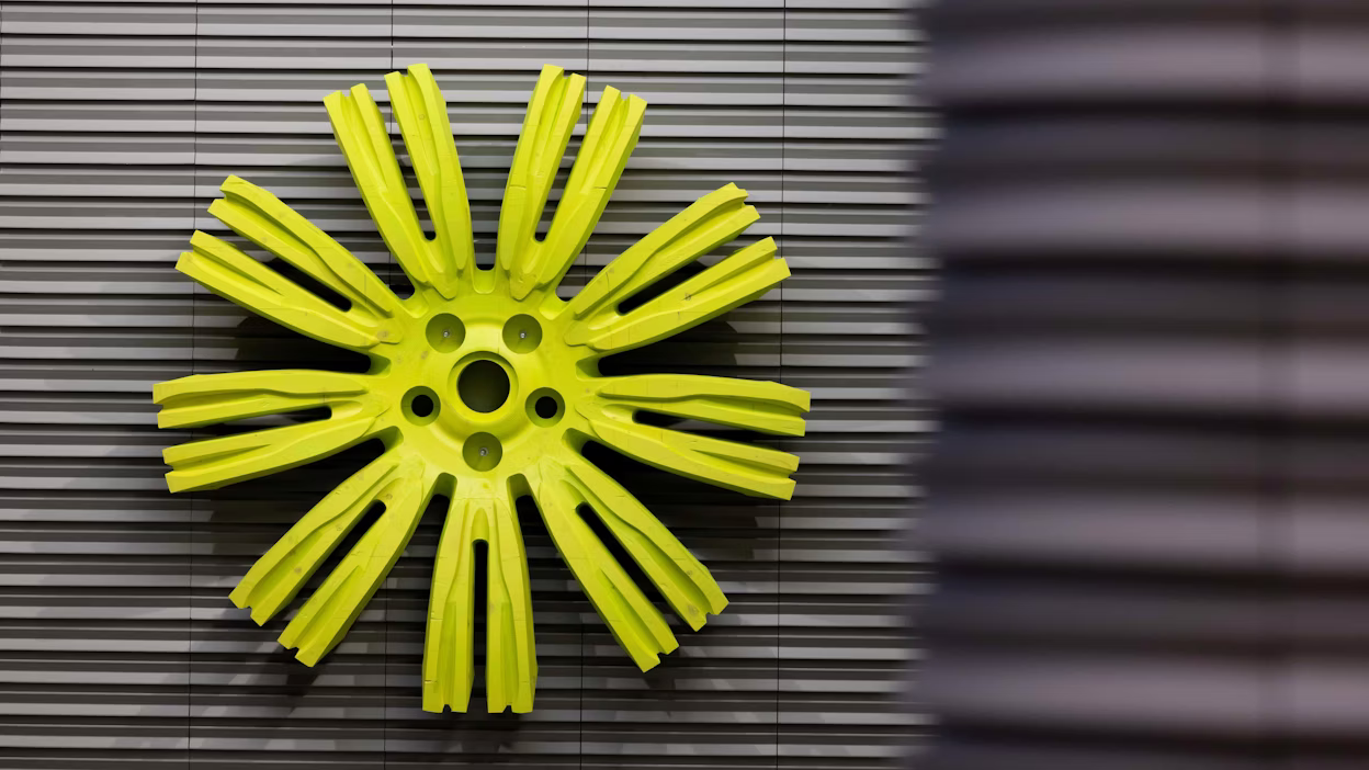 Art piece resembling a lime green round rim on a metallic background.