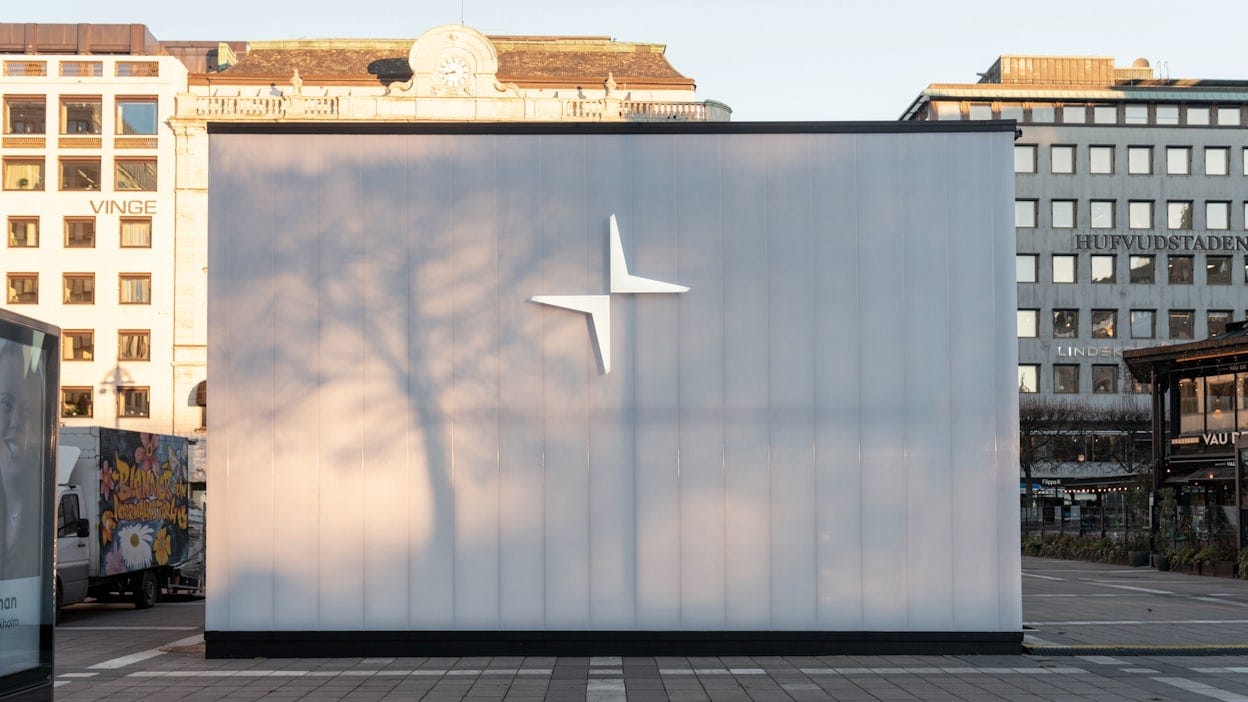 Close up of the Polestar cube in Norrmalmstorg showing a big logo and white wall.